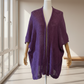 Purple Haze alpaca mohair cape displayed on a modern bust with wooden arms